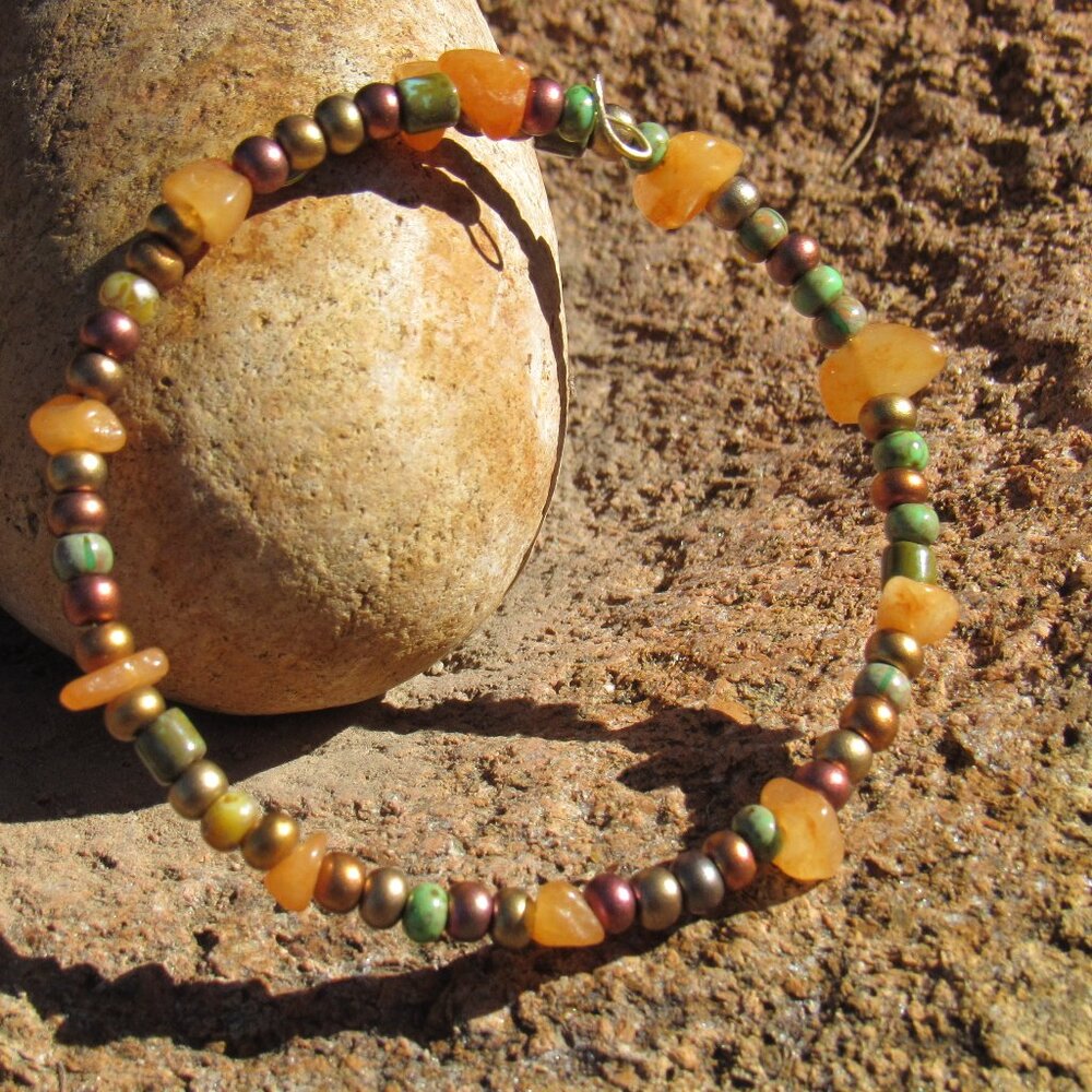 Hand crafted, one of a kind bead bracelet on gold wire coil. One size fits most